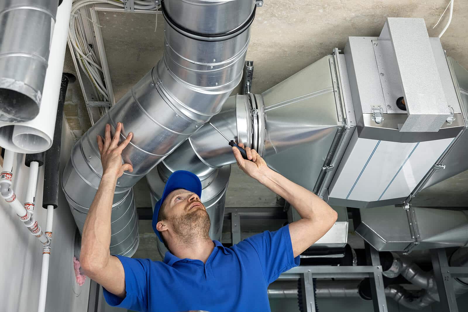 HVAC technician inspecting and repairing air ducts in Moreno Valley