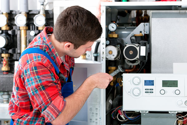 Heating technician repairing boiler controls in Moreno Valley