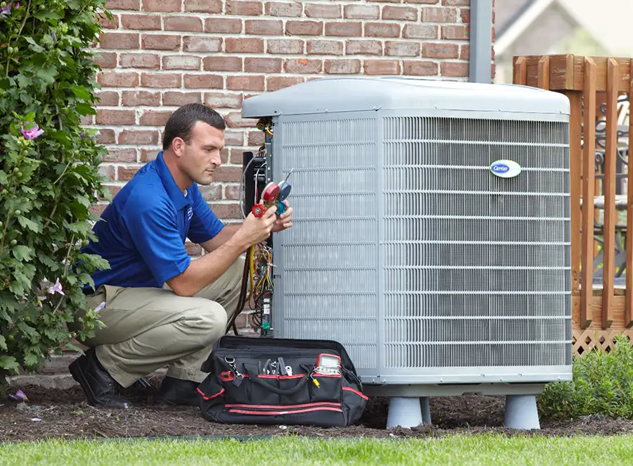 HVAC technician inspecting an outdoor AC unit in Moreno Valley