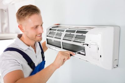 HVAC technician maintaining a ductless air conditioner in Moreno Valley