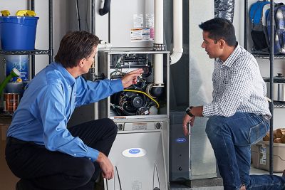 Technician evaluating a furnace for repair or replacement in Moreno Valley